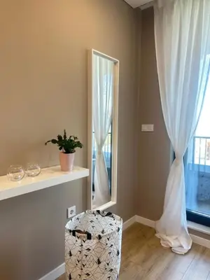 a room with a window with curtains and a stool at Апартамент В 54 в Сграда МОНА in Sofia