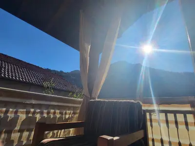 a view of the sun shining through a fence at Йони in Teteven