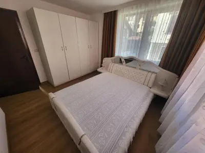 a small bedroom with a bed and a window at Йони in Teteven