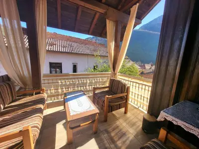 a room with a balcony with a view of a mountain at Йони in Teteven