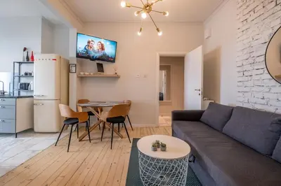 a living room with a couch and a table at Spacious & Central 2BR with Terrace, Cozy & Modern by Flat Mаnager in Sofia