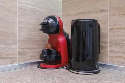 a red and black appliance sitting on a counter at Cozy Corner-Heart of Plovdiv in Plovdiv
