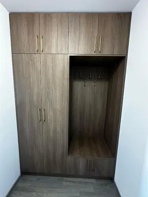 a closet with wooden cabinets in a room at Apartment Aria 6 in Velingrad