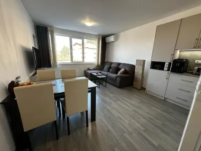 a living room with a table and chairs and a couch at Apartment Aria 6 in Velingrad