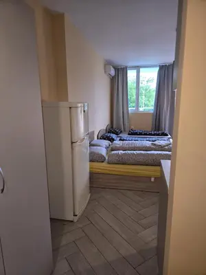 a small room with two beds and a refrigerator at Green Oasis in Sofia