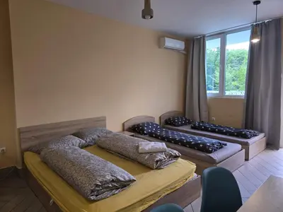 a room with two beds with pillows and a window at Green Oasis in Sofia