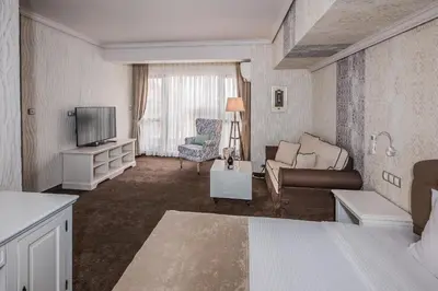 a living room with a couch and a television at 8 1/2 Art Guest House in Plovdiv