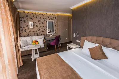 a hotel room with a bed and a desk at 8 1/2 Art Guest House in Plovdiv