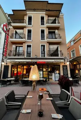 a building with a table and chairs in front of it at 8 1/2 Art Guest House in Plovdiv