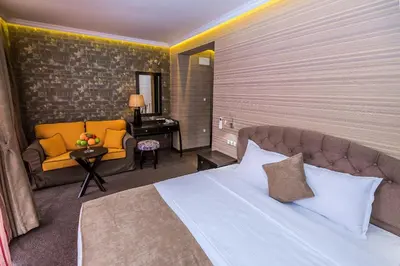 a hotel room with a bed and a couch at 8 1/2 Art Guest House in Plovdiv