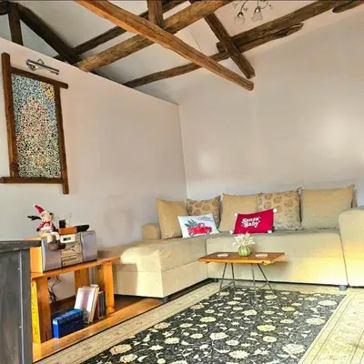 a living room with a couch and a table at Balkan Barn in Tŭzha