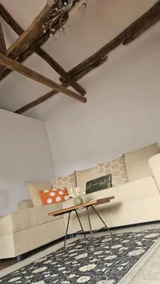 a living room with a couch and a table at Balkan Barn in Tŭzha
