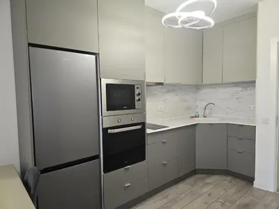 a kitchen with white cabinets and a microwave at The Oligarchs Outlook in Sofia