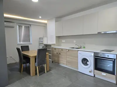 a kitchen with a table and a washing machine at The Ascent in Sofia