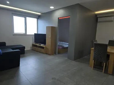 a living room with a couch and a television at The Ascent in Sofia