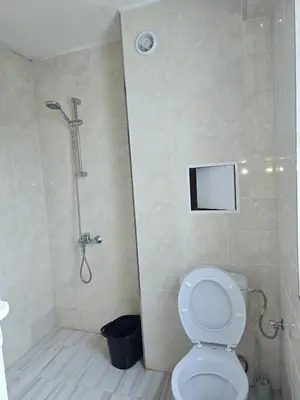 a bathroom with a shower with a toilet and a shower at The Ascent in Sofia