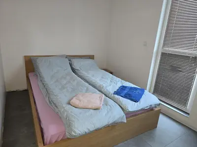a bed with two pillows on it in a room at The Ascent in Sofia