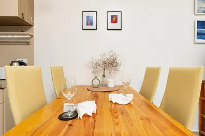 a dining room table with wine glasses and chairs at Azuuro - 1BD near the city center by Flat Manager in Plovdiv