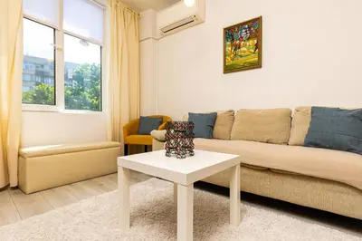 a living room with a couch and a table at Azuuro - 1BD near the city center by Flat Manager in Plovdiv