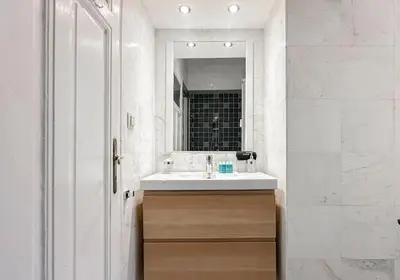 a bathroom with a sink and a mirror at Classic Charm - 2BD central Apartment by FlatManager in Sofia