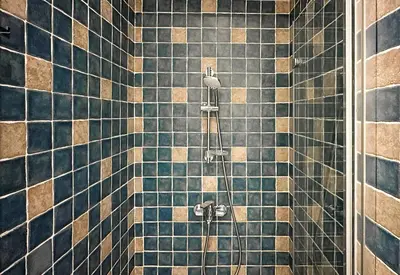 a bathroom with a shower with blue tiles at Classic Charm - 2BD central Apartment by FlatManager in Sofia