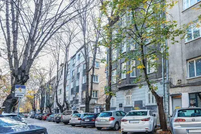 a row of cars parked on a street next to buildings at Classic Charm - 2BD central Apartment by FlatManager in Sofia