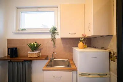 a small kitchen with a sink and a window at Sunny Top Floor Apartment near Tokuda Hospital & Paradise Mall in Sofia