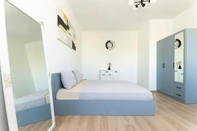 a bedroom with a bed and a mirror at Sunny Top Floor Apartment near Tokuda Hospital & Paradise Mall in Sofia