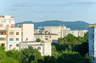 a group of buildings in a city with trees at Sunny Top Floor Apartment near Tokuda Hospital & Paradise Mall in Sofia