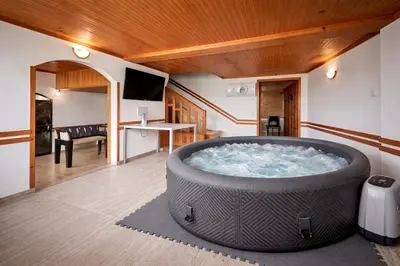 a large hot tub in a room with a table at Villa High Point in Pravets