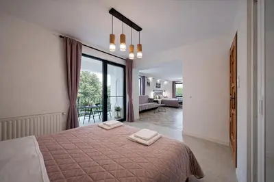 a bedroom with a bed with two towels on it at Villa High Point in Pravets