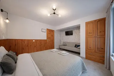 a bedroom with a bed and a couch at Villa High Point in Pravets
