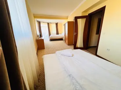 a room with two beds in a hotel room at Ardo Hill Spa Hotel and Restaurant in Sarnitsa