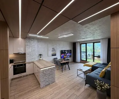 a kitchen and living room with a couch and a table at Business Park Premium, 2B lux flat, free garage in Sofia