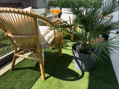 a chair and a table and some plants on a patio at Business Park Premium, 2B lux flat, free garage in Sofia