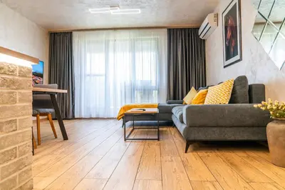 a living room with a couch and a table at Business Park Premium, 2B lux flat, free garage in Sofia