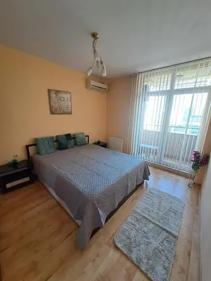 a bedroom with a bed and a large window at Apartment-10 min from Sofia airport in Sofia