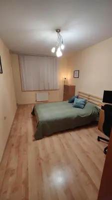 a bedroom with a bed and a desk in it at Apartment-10 min from Sofia airport in Sofia
