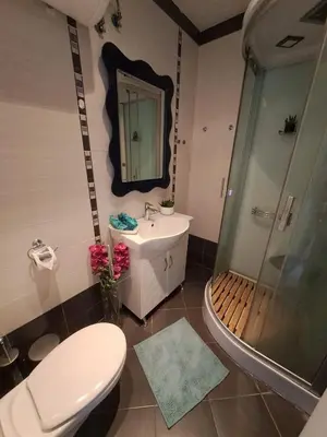 a bathroom with a toilet and a sink and a shower at Apartment-10 min from Sofia airport in Sofia