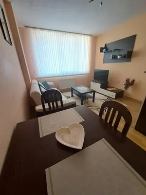 a living room with a table with a heart on it at Apartment-10 min from Sofia airport in Sofia