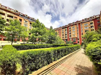a building with a row of bushes in front of it at Apartment-10 min from Sofia airport in Sofia