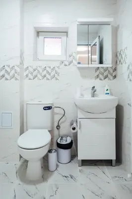 a white bathroom with a toilet and a sink at Къща Инфинити Лукс и Уют, Вплетени в Спомени in Sapareva Banya