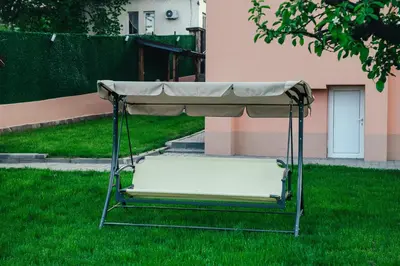 a swing in the grass in a yard at Апартамент Инфинити in Sapareva Banya