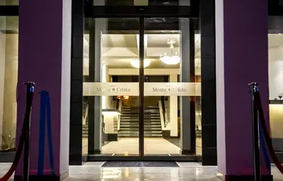 a door to a building with a sign on it at Hotel Monte Cristo in Blagoevgrad
