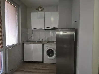 a kitchen with a refrigerator and a washing machine at The Alma Mater in Sofia
