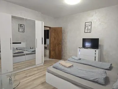 a living room with two beds and a television at The Alma Mater in Sofia