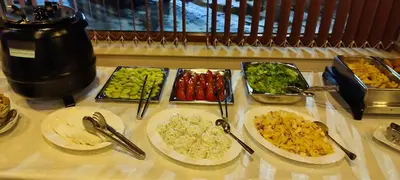 a table with plates of food on a table at Guest House Edelweiss in Govedartsi