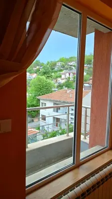 a window with a view of a building at Арт мезонет под тепето in Plovdiv
