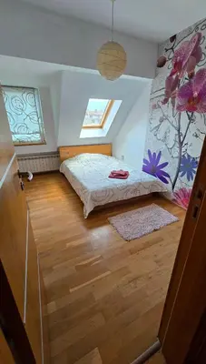 a bedroom with a bed in a room at Арт мезонет под тепето in Plovdiv