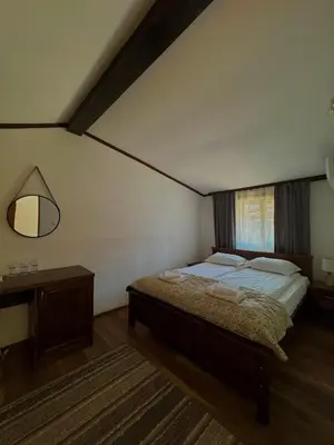 a bedroom with a large bed and a window at Комплекс Варвара - Хотел и Минерални басейни in Varvara